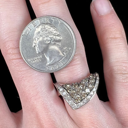 A ladies' white gold ring set with clusters of brown champagne and white diamonds.
