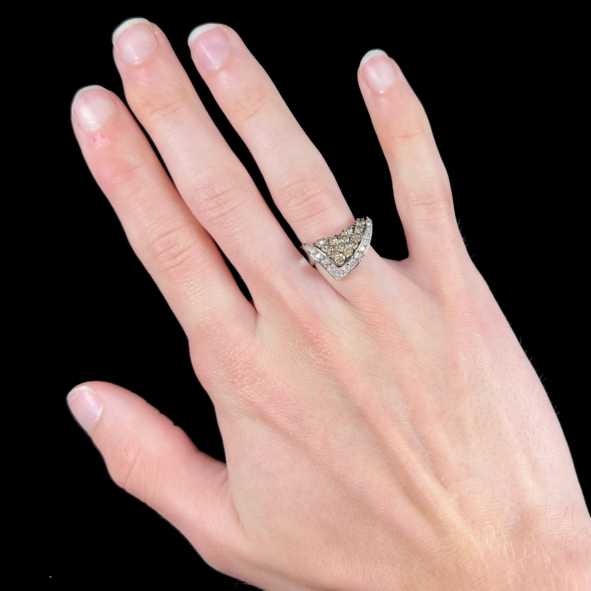 A ladies' white gold ring set with clusters of brown champagne and white diamonds.