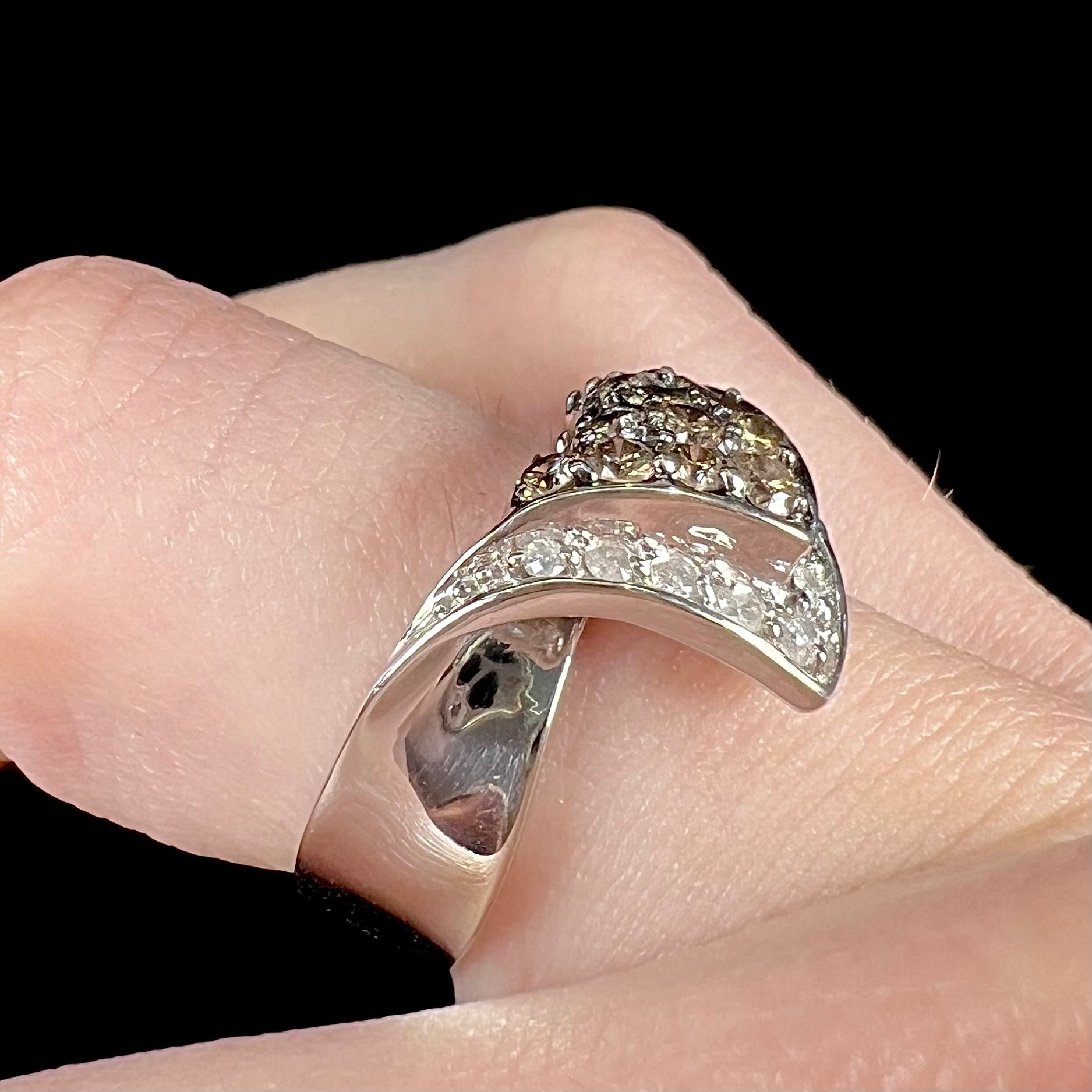 A ladies' white gold ring set with clusters of brown champagne and white diamonds.