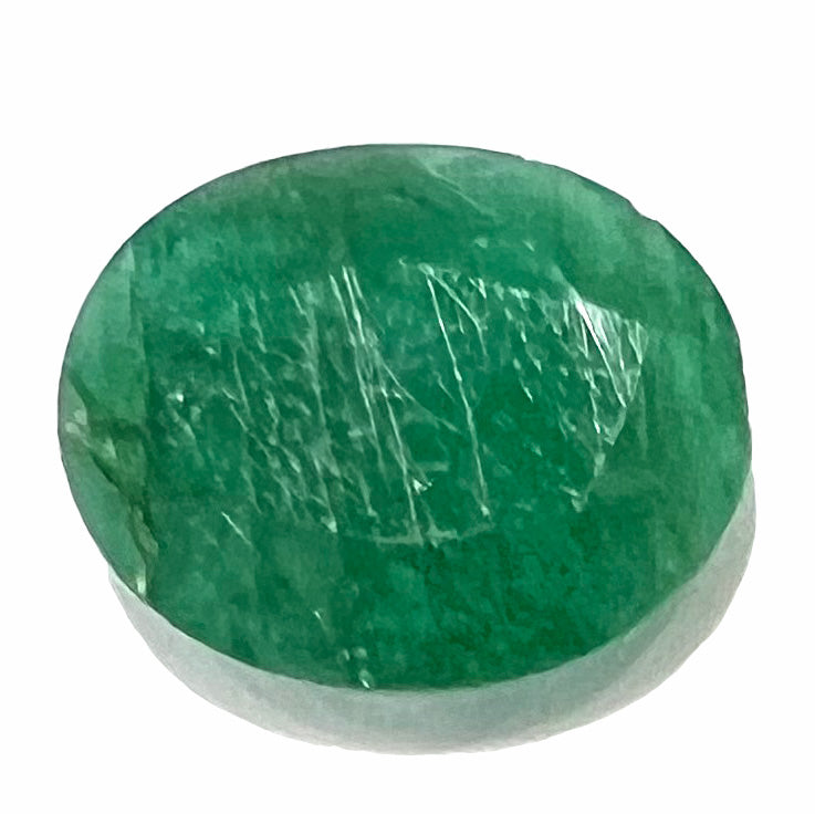 A loose, faceted oval cut commercial grade emerald stone.  The gem weighs 4.23 carats.