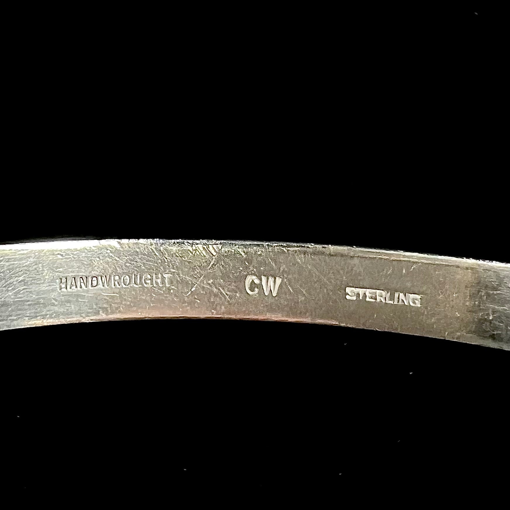 A ladies' sterling silver bangle bracelet stamped "CW" by the Hopi Indian artist, Cheryl Wadsworth.
