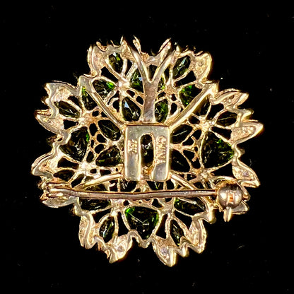 A ladies' pendant set with green chrome diopside stones and diamonds.  The pendant can be worn as a brooch.