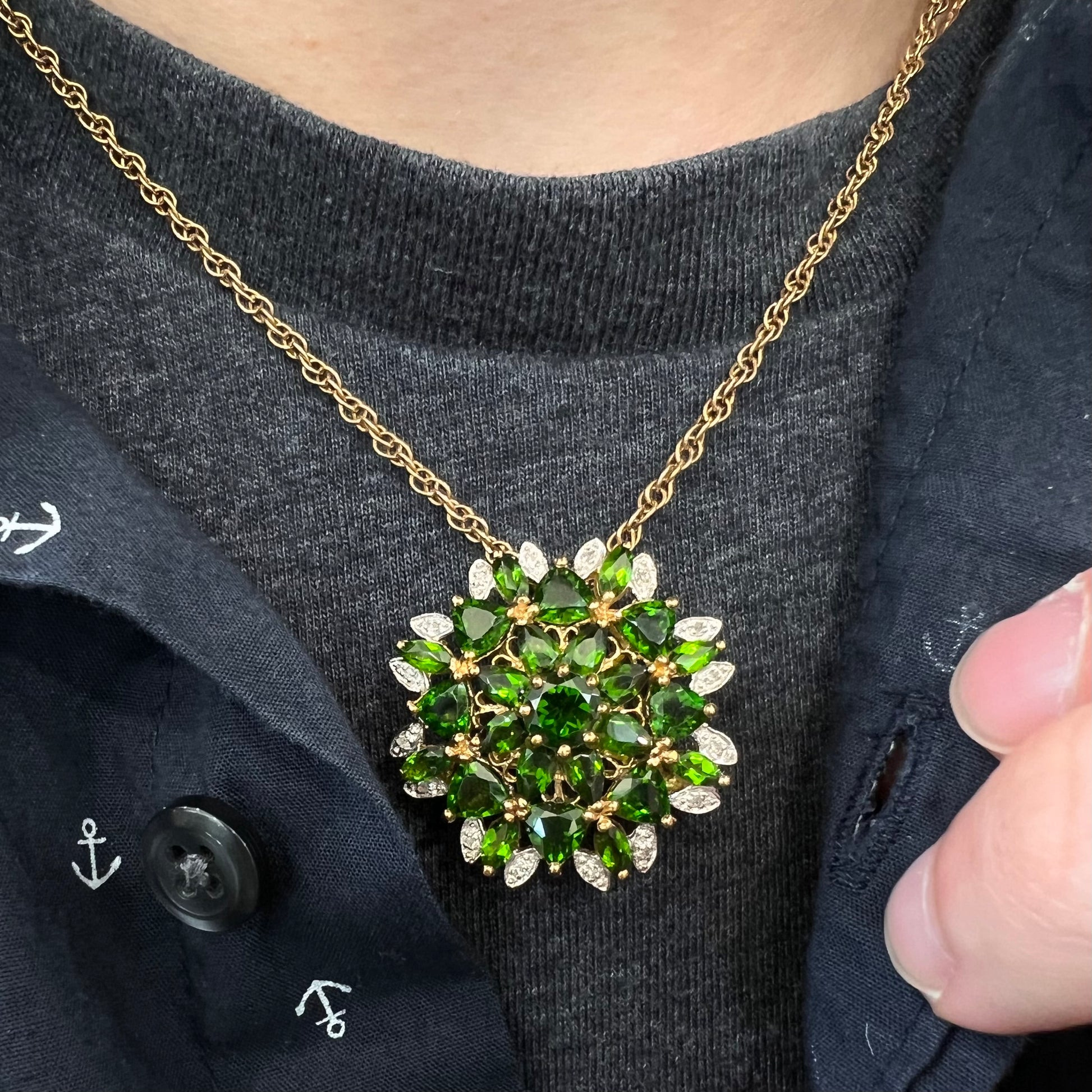 A ladies' pendant set with green chrome diopside stones and diamonds.  The pendant can be worn as a brooch.