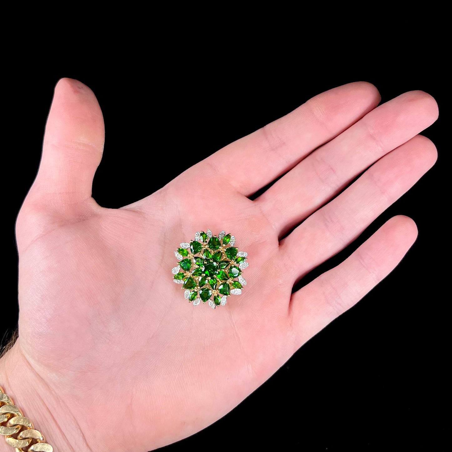 A ladies' pendant set with green chrome diopside stones and diamonds.  The pendant can be worn as a brooch.