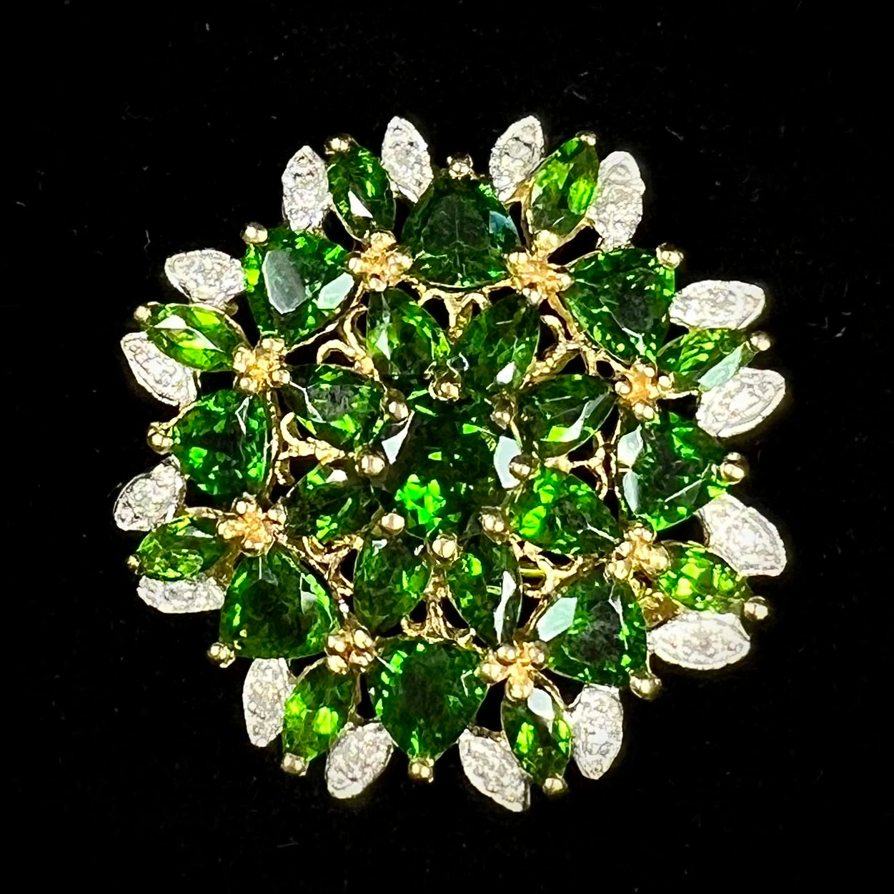 A ladies' pendant set with green chrome diopside stones and diamonds.  The pendant can be worn as a brooch.