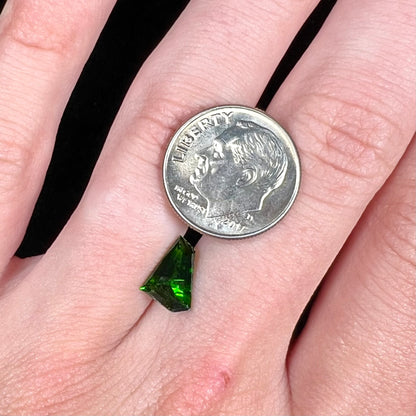 A freeform shield cut chrome diopside gemstone.