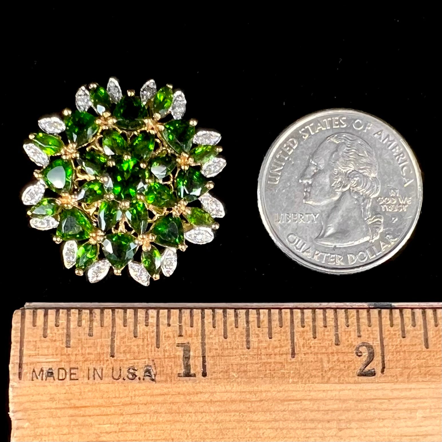 A ladies' pendant set with green chrome diopside stones and diamonds.  The pendant can be worn as a brooch.