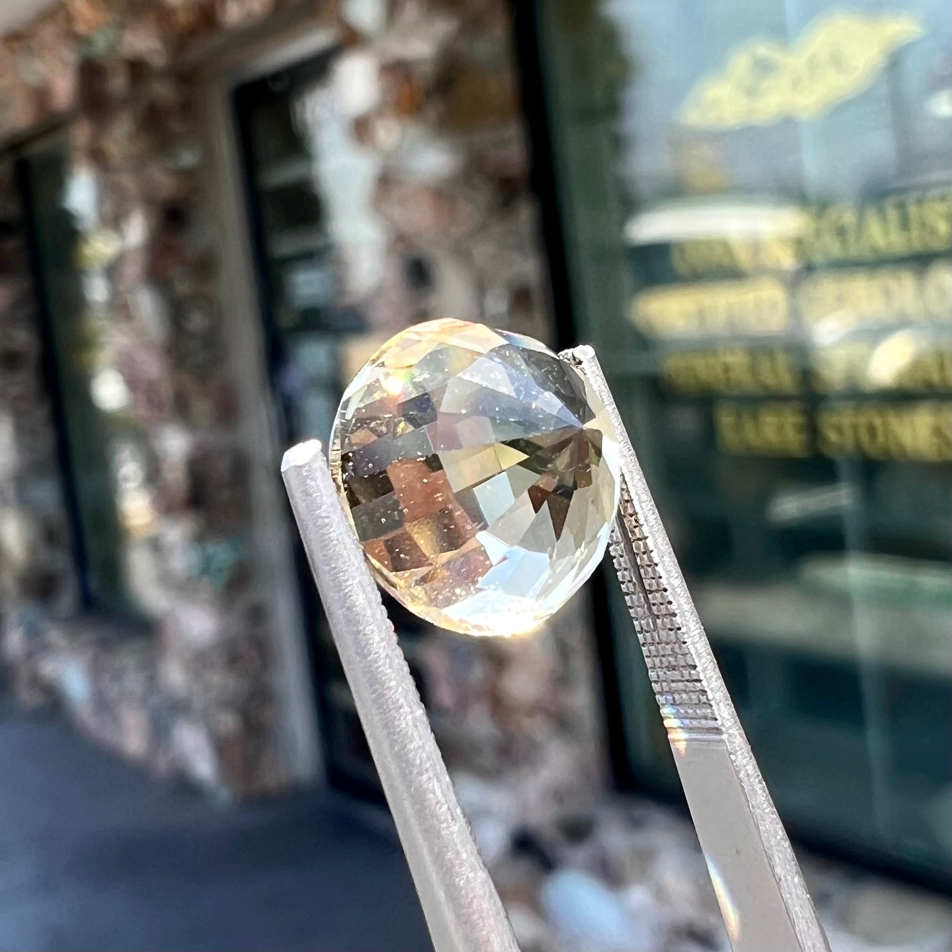 A loose, round brilliant cut citrine gemstone.  The stone is light yellow color.