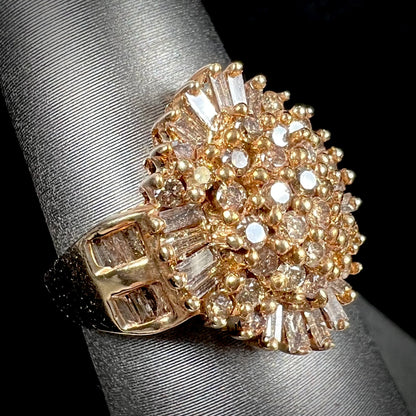 A ladies' cluster ring set with round and baguette cut cognac brown diamonds.