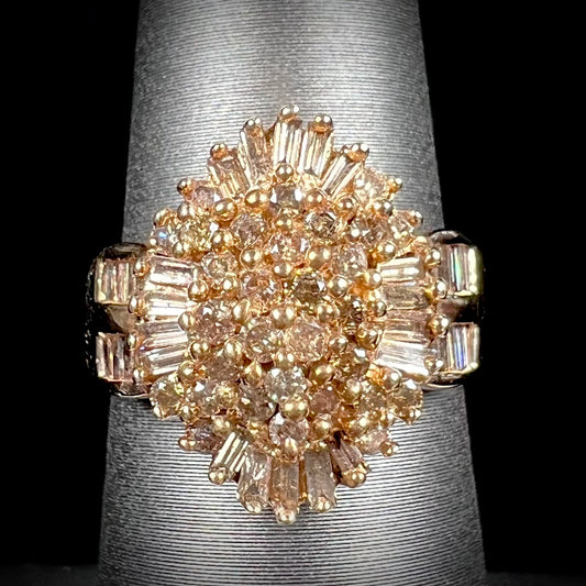 A ladies' cluster ring set with round and baguette cut cognac brown diamonds.