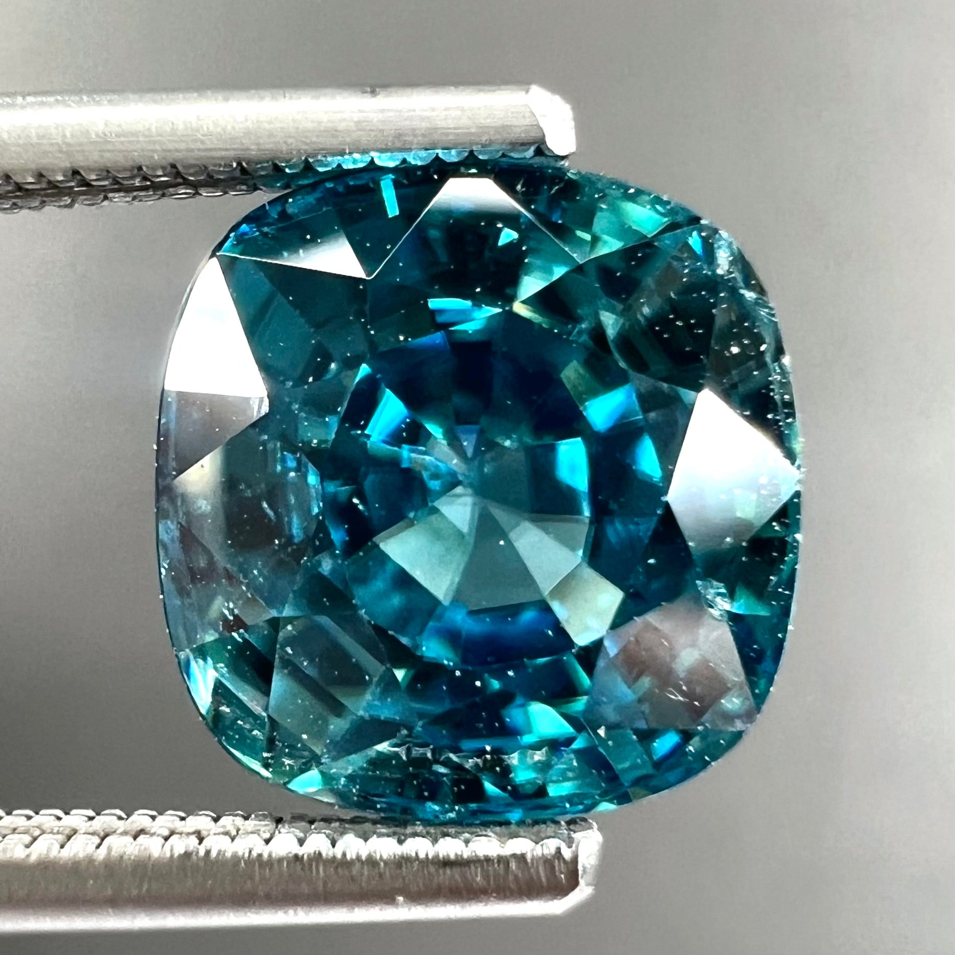 A loose cushion cut blue zircon stone.