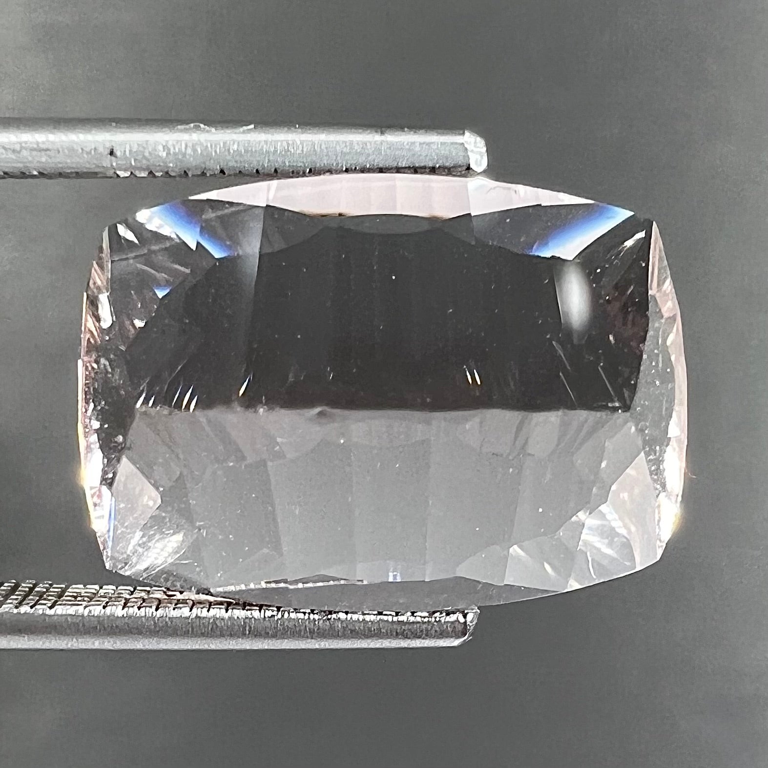 A loose, modified cushion cut pink morganite stone.