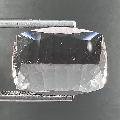 A loose, modified cushion cut pink morganite stone.