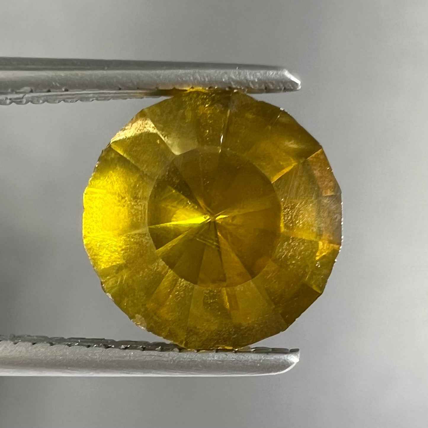 A loose, modified round brilliant cut sphalerite gemstone.