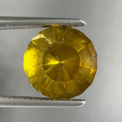 A loose, modified round brilliant cut sphalerite gemstone.