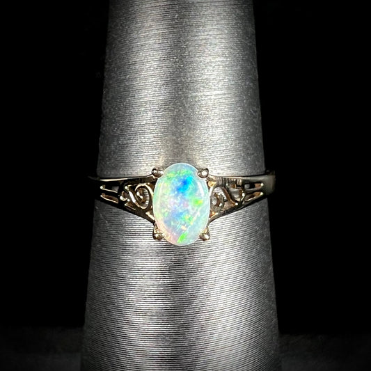 Ladies' 10 karat yellow gold opal solitaire ring.  The ring has filigree accents.