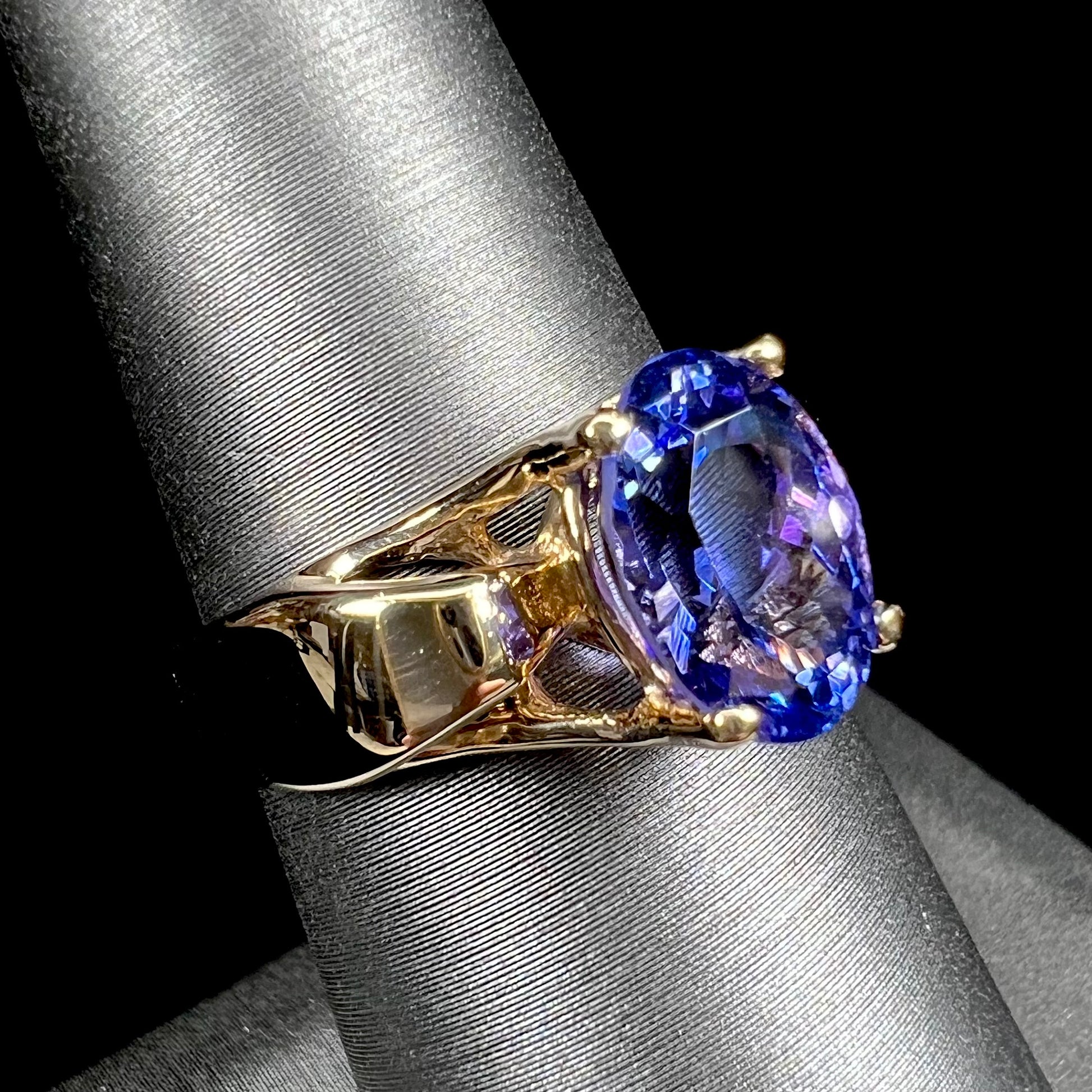 A ladies' oval cut tanzanite solitaire ring set in yellow gold.