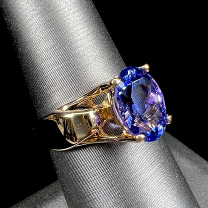 A ladies' oval cut tanzanite solitaire ring set in yellow gold.