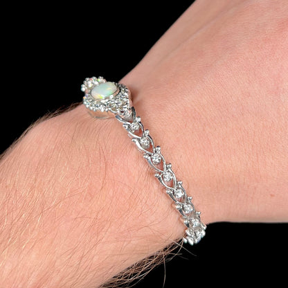 A ladies' vintage, 1930's natural opal bracelet set with accent diamonds in white gold.