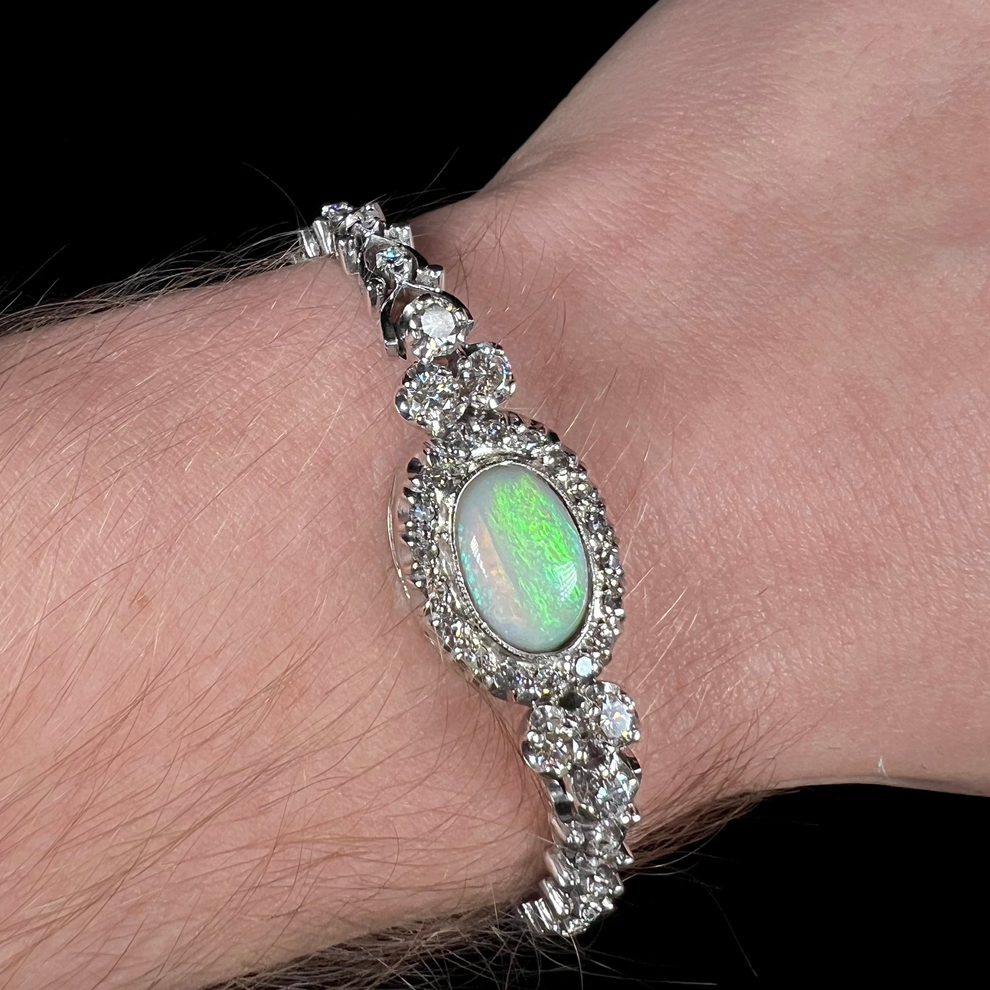 A ladies' vintage, 1930's natural opal bracelet set with accent diamonds in white gold.