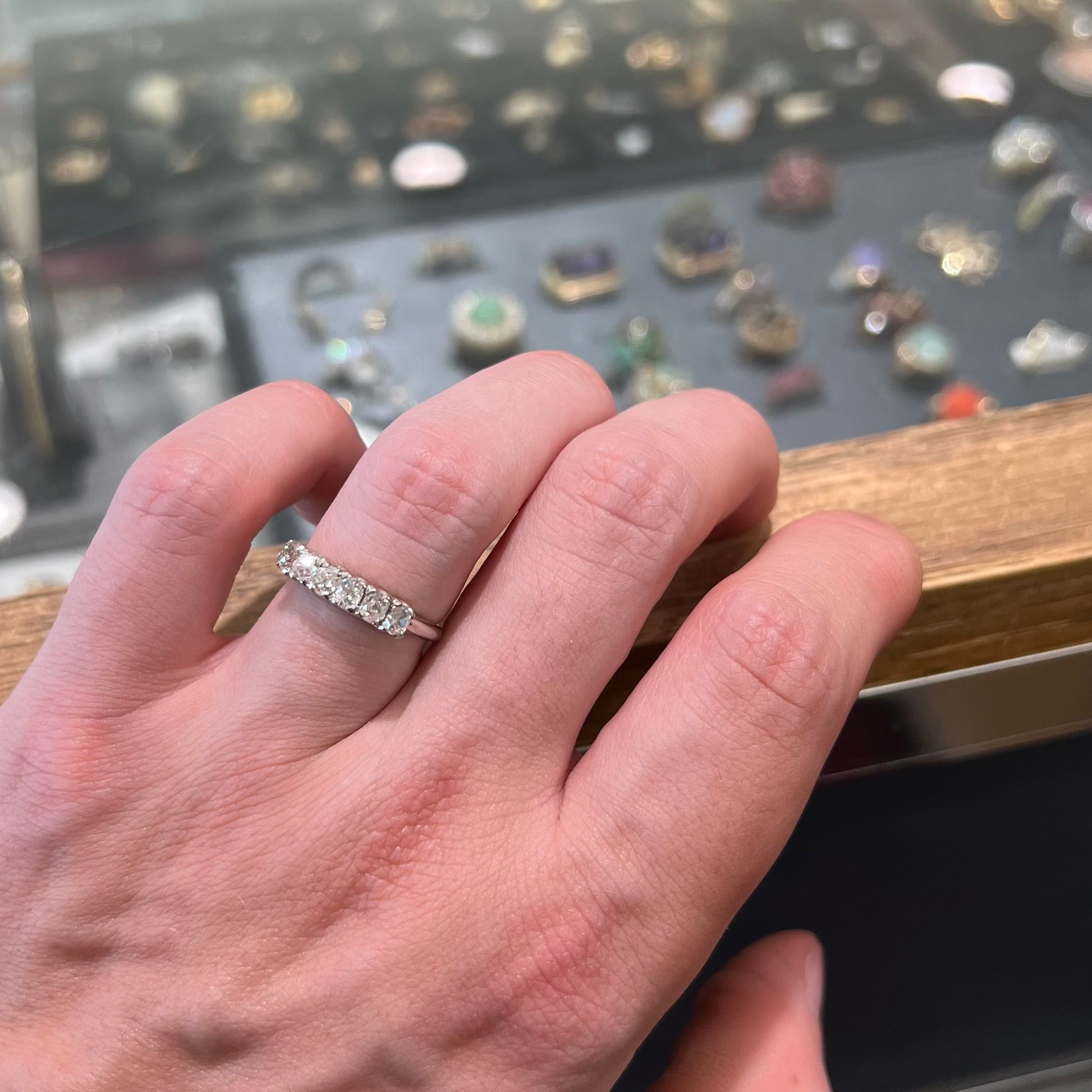 An antique white gold diamond wedding band set with six old mine cut natural diamonds.