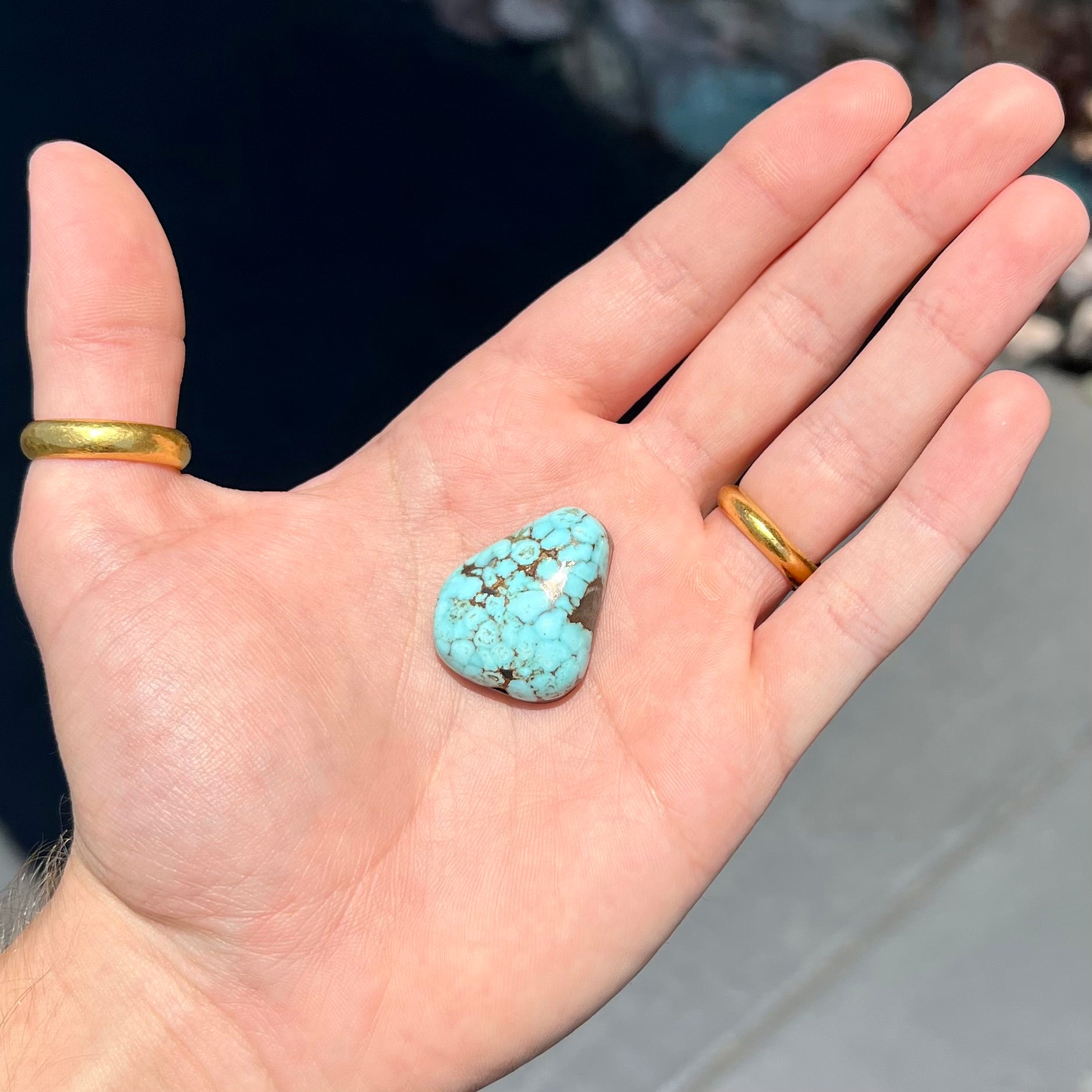 A loose, triangular drop shape Dry Creek turquoise stone.