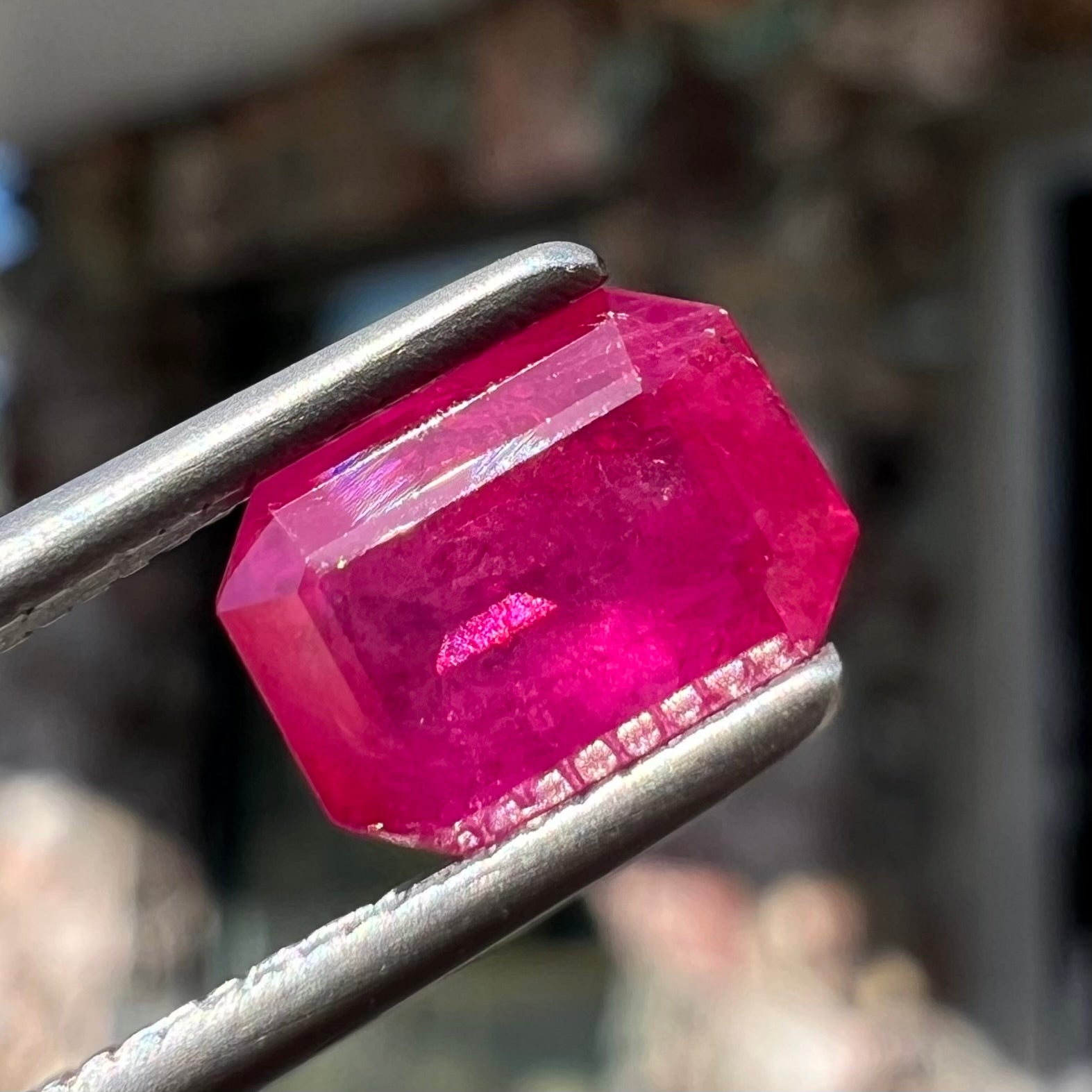 A natural, emerald cut Burma ruby with a purplish pinkish red color.