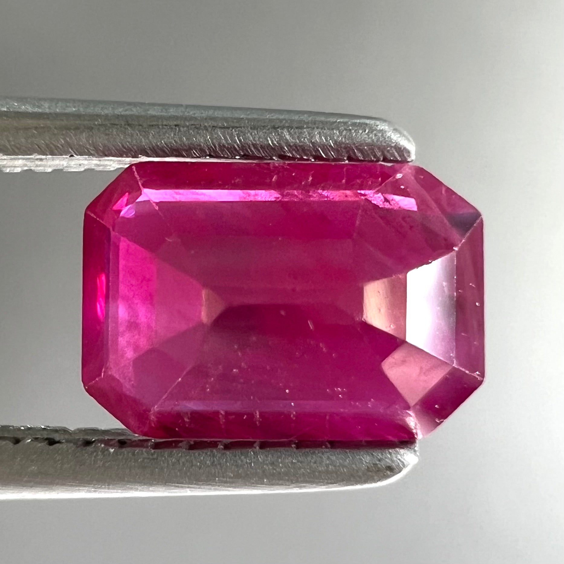 A natural, emerald cut Burma ruby gemstone.  The stone is pinkish red color.