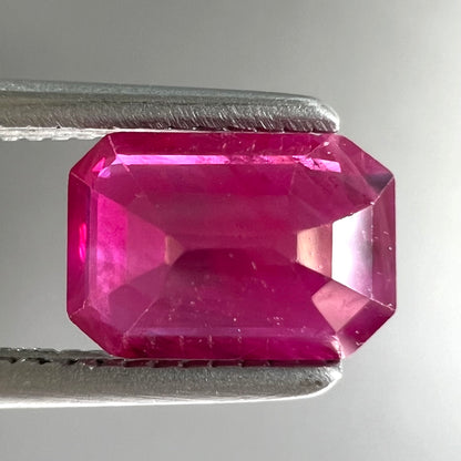 A natural, emerald cut Burma ruby gemstone.  The stone is pinkish red color.