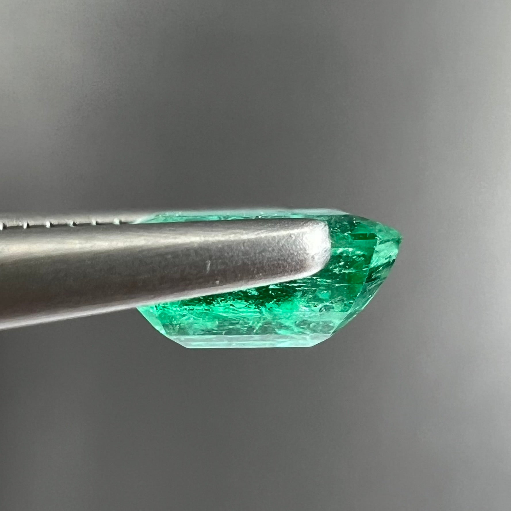 A loose, natural emerald gemstone.  The stone is emerald cut.