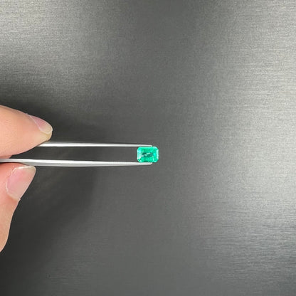 A loose, natural emerald gemstone.  The stone is emerald cut.