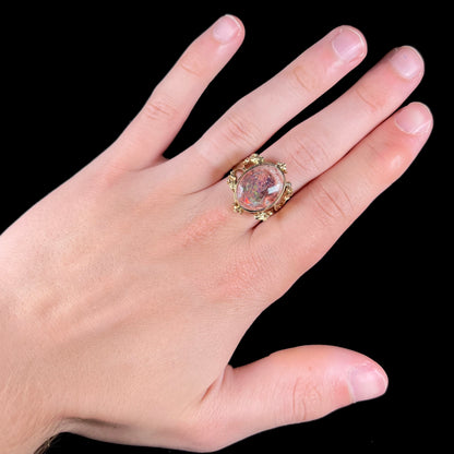 A ladies' estate yellow gold solitaire ring set with an oval cabochon cut natural Cantera fire opal.