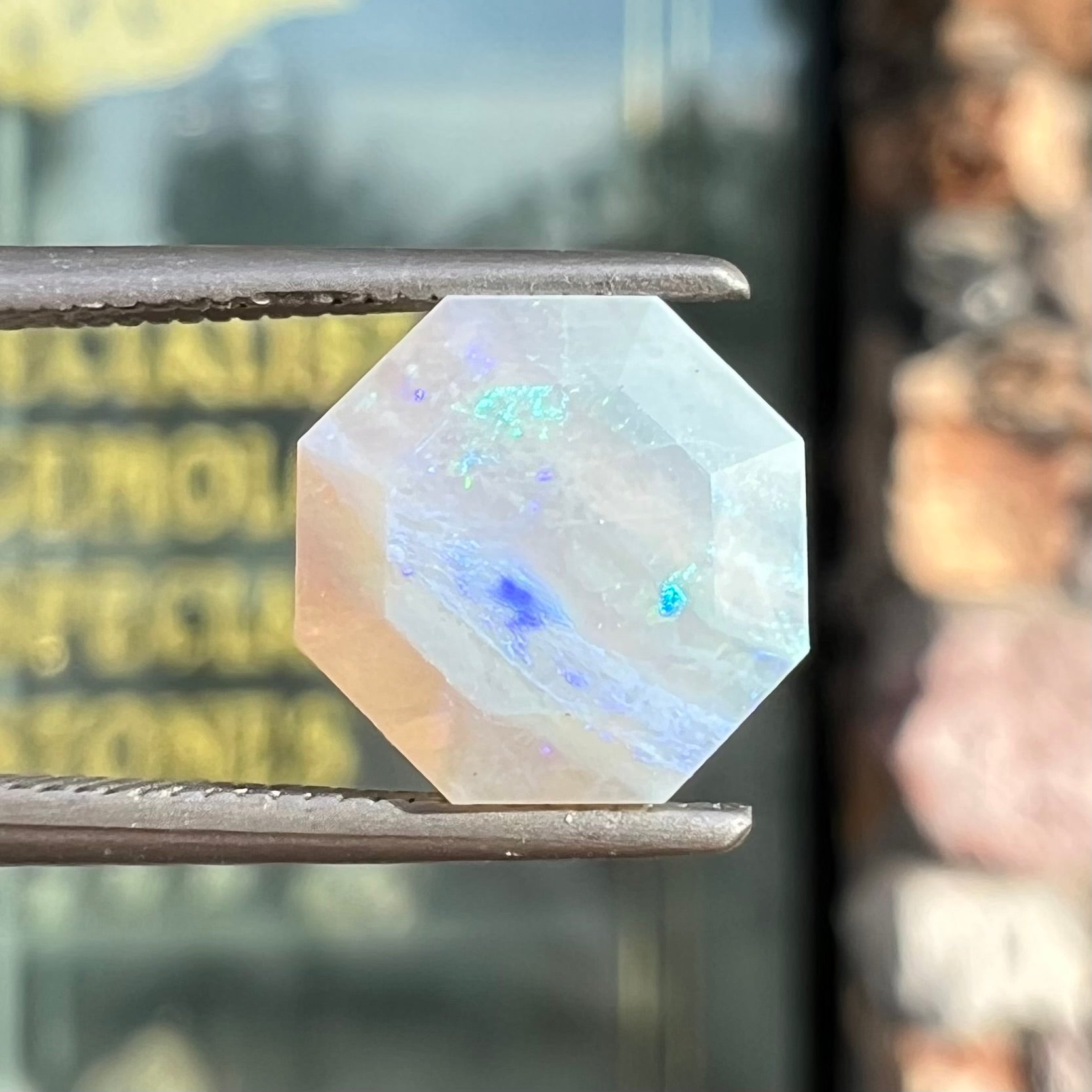 A loose, faceted octagon gray base crystal opal from Lightning Ridge, Australia.