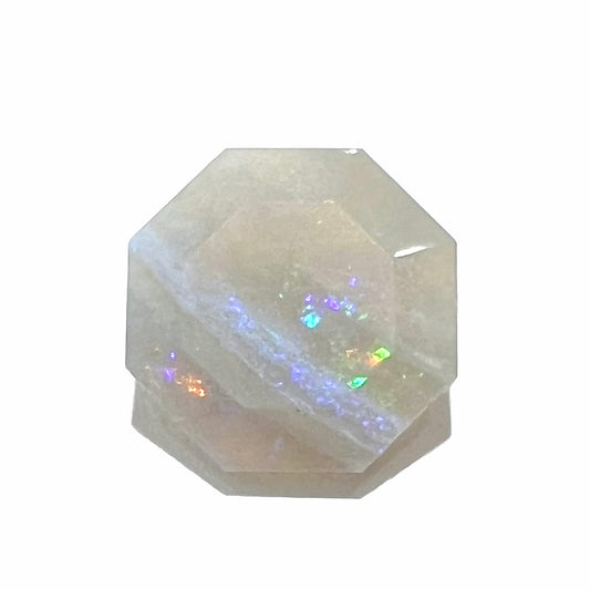 A loose, faceted octagon gray base crystal opal from Lightning Ridge, Australia.