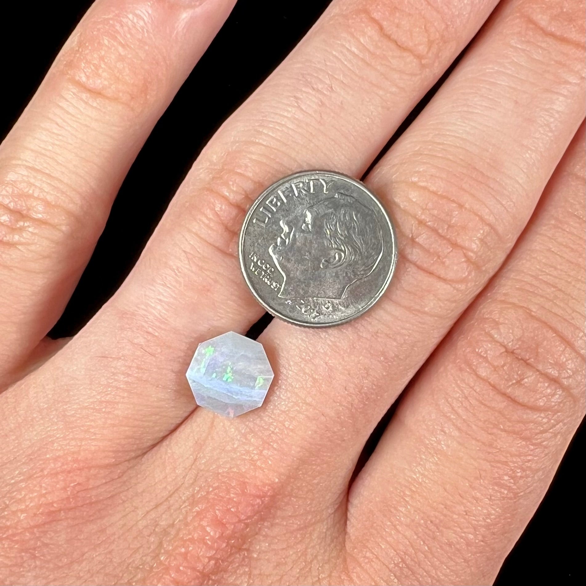 A loose, faceted octagon gray base crystal opal from Lightning Ridge, Australia.