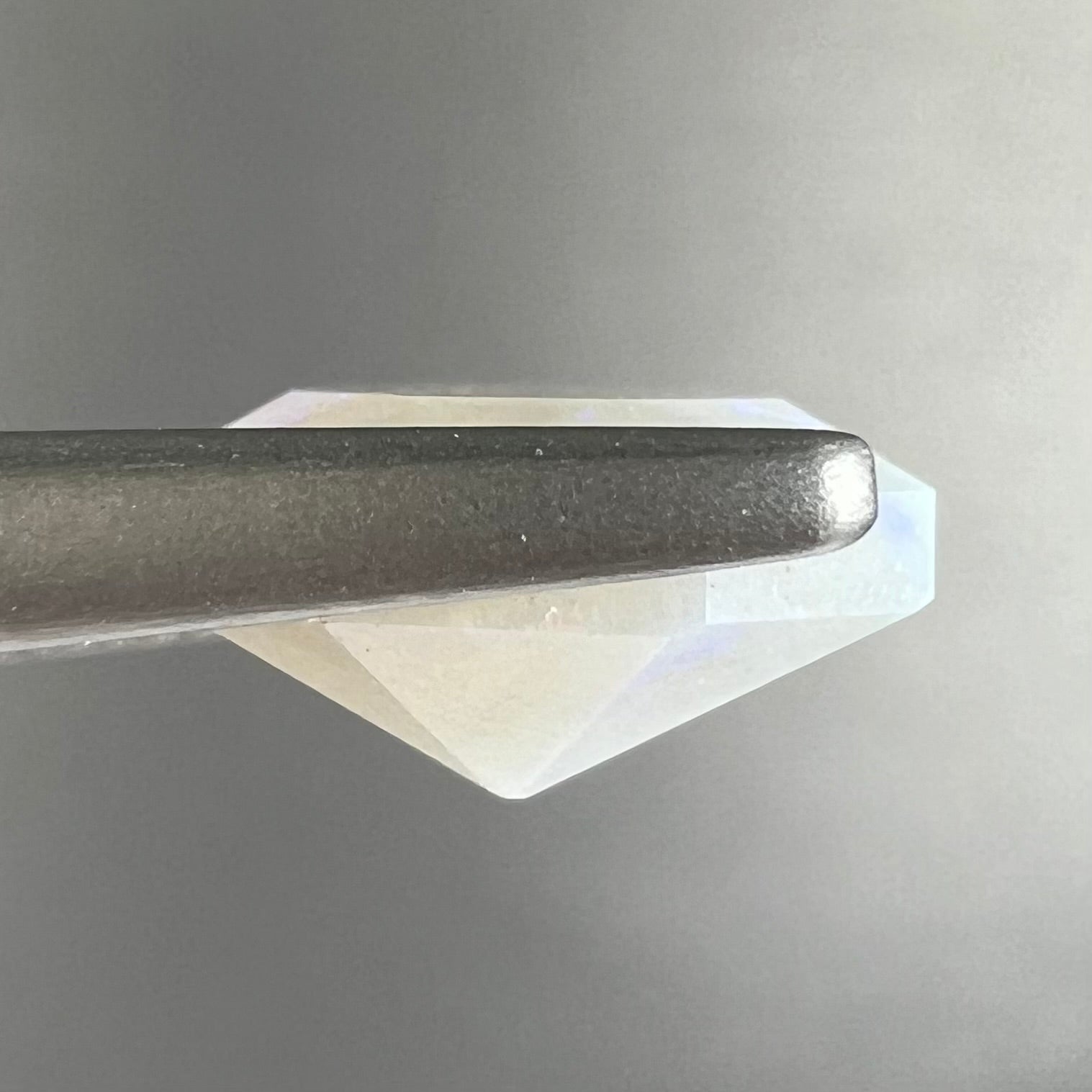 A loose, faceted octagon gray base crystal opal from Lightning Ridge, Australia.