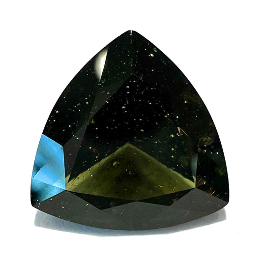 A faceted trillion cut moldavite gemstone that weighs 3.98 carats.  The stone is a dark green color.