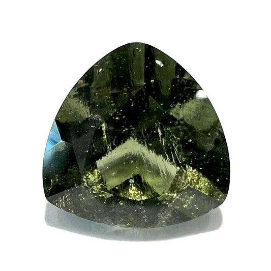 A loose, faceted trillion cut moldavite stone that weighs 2.73 carats.