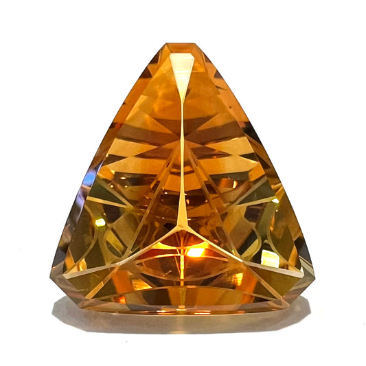 A loose, triangular fantasy cut yellow citrine stone cut by Arthur Lee Anderson.
