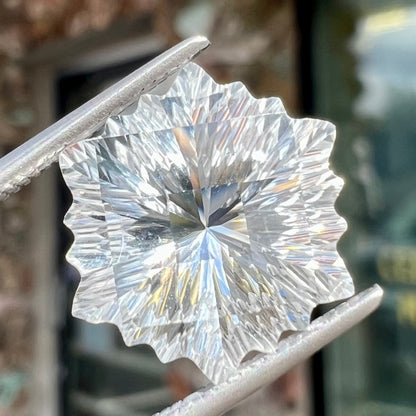A fantasy snowflake cut white topaz gemstone.