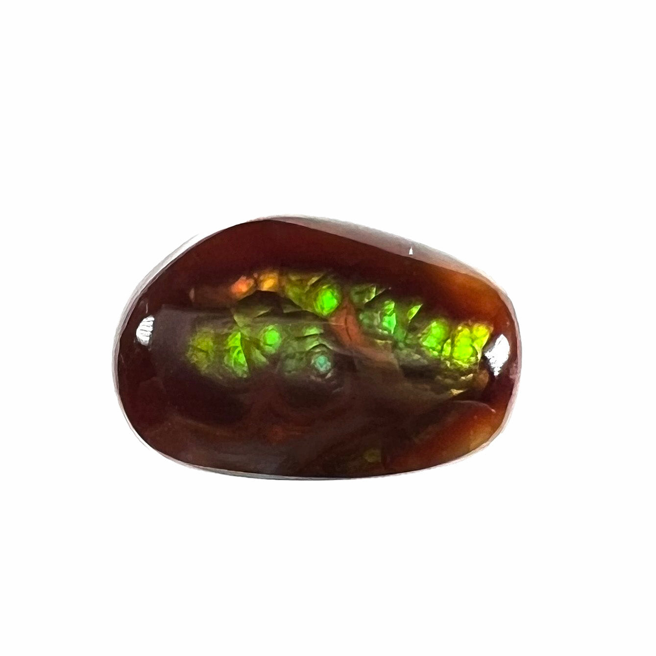 A loose, freeform cabochon cut fire agate gemstone.  The stone is green with blue overtones.