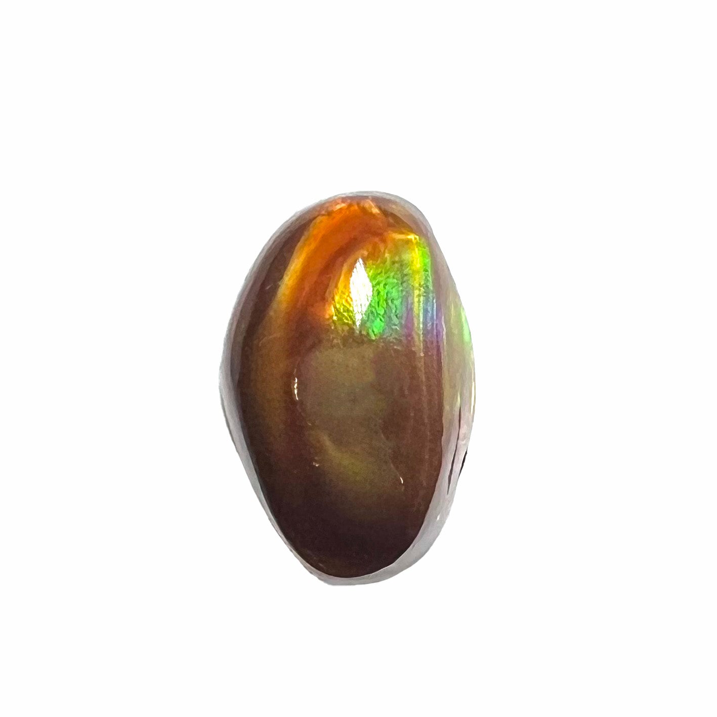 A loose, oval cabochon cut fire agate stone that shines red, yellow, green, blue, and purple.