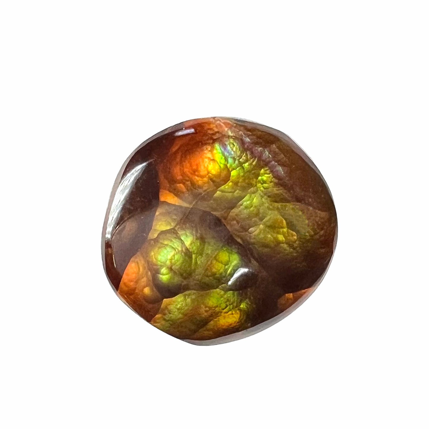 A loose, round cabochon cut fire agate stone.  The gem is green with orange, red, blue, and a purple stripe.