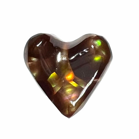 A cabochon cut heart shaped Mexican fire agate stone.  The stone is orange, yellow, pink, green, and purple.