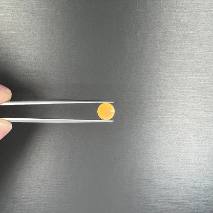 A loose, faceted round cut fire opal from Mexico.  The stone is yellow orange in body color.