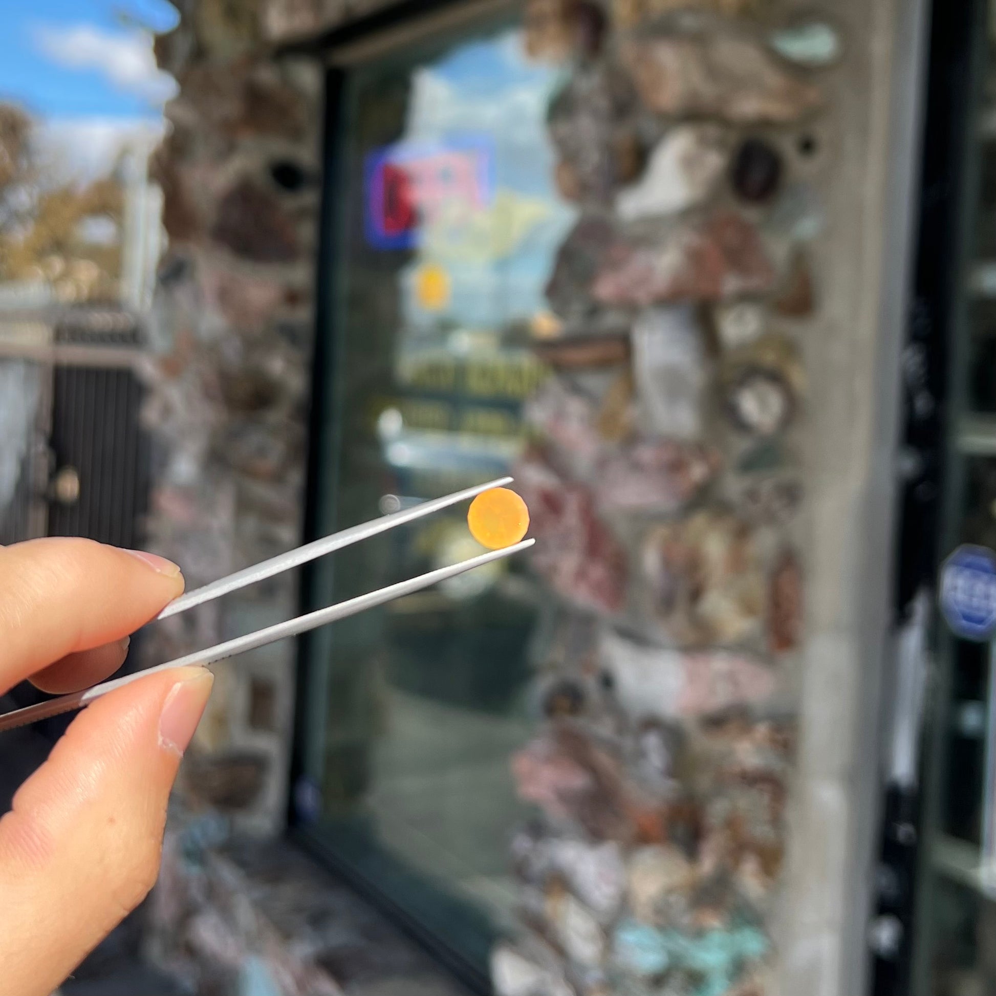A loose, faceted round cut fire opal from Mexico.  The stone is yellow orange in body color.