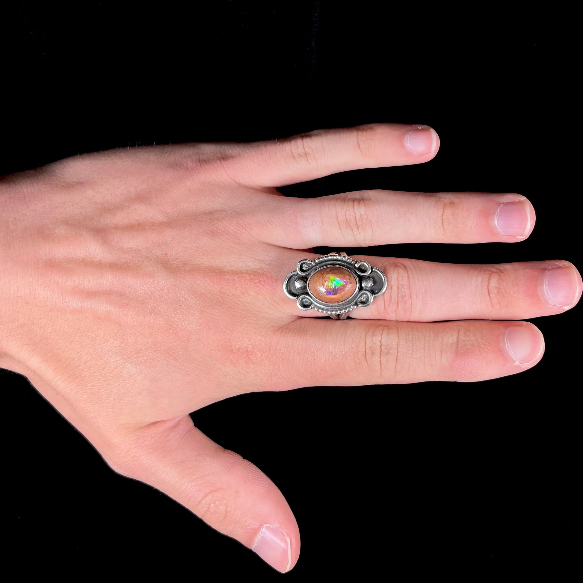 A vintage, Navajo style sterling silver ring set with an oval cabochon cut cantera fire opal stone.