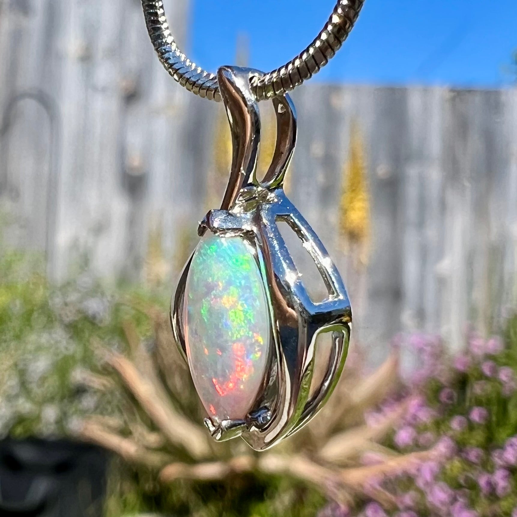 A natural, marquise cut white crystal opal necklace in sterling silver.