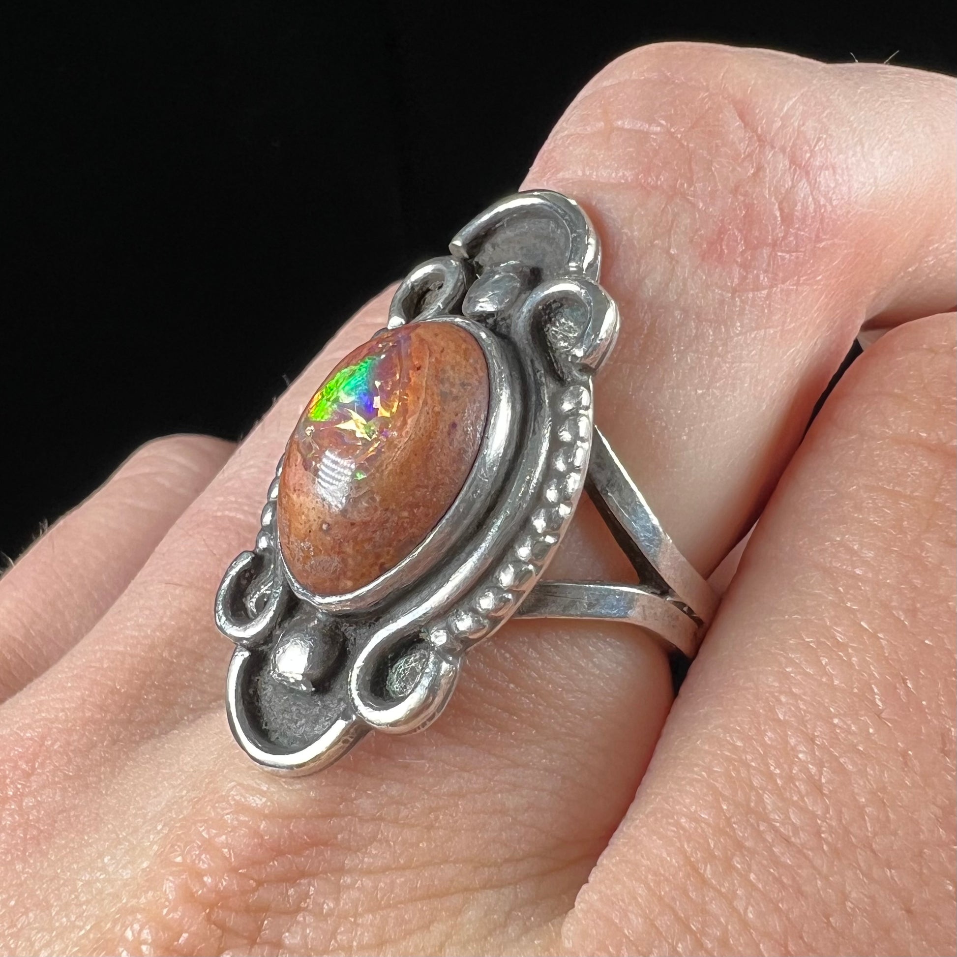 A vintage, Navajo style sterling silver ring set with an oval cabochon cut cantera fire opal stone.