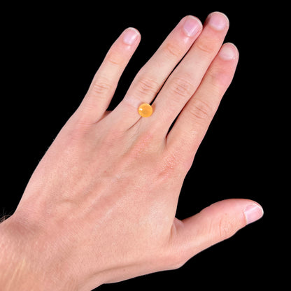 A loose, faceted round cut fire opal from Mexico.  The stone is yellow orange in body color.